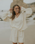 Mid-length muslin beach shorts for women in cream.