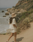 Neutral matching beachwear set for women.