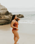 Cute, modest rust colored one piece swimsuit, with ties in the back and front.