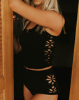 Textured modest black tankini top with floral cutouts.