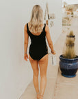 Modest black high waisted bikini bottoms. Floral cutouts.