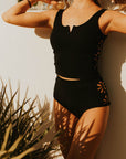 Textured modest black tankini top with floral cutouts.