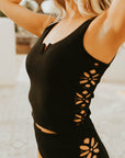 Textured modest black tankini top with floral cutouts.