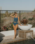 Modest teal tankini with textured material.
