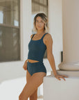 Modest teal tankini with textured material.