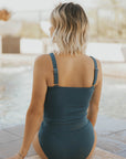 Modest teal tankini with textured material.