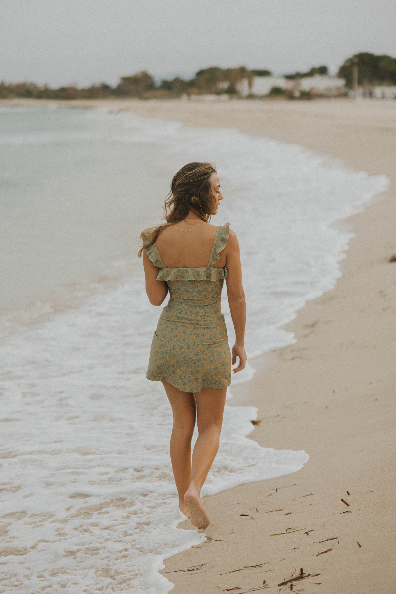 Feminine full coverage green floral swimsuit with swim skirt for spring