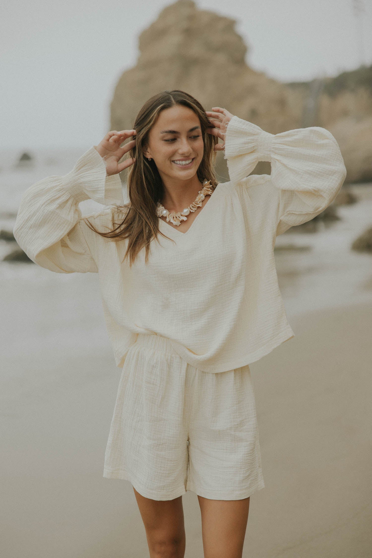 Mid-length muslin beach shorts for women in cream.
