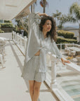 Striped long sleeve matching shorts and top beachwear set for women.