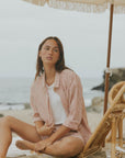 Striped long sleeve matching shorts and top beachwear set for women.