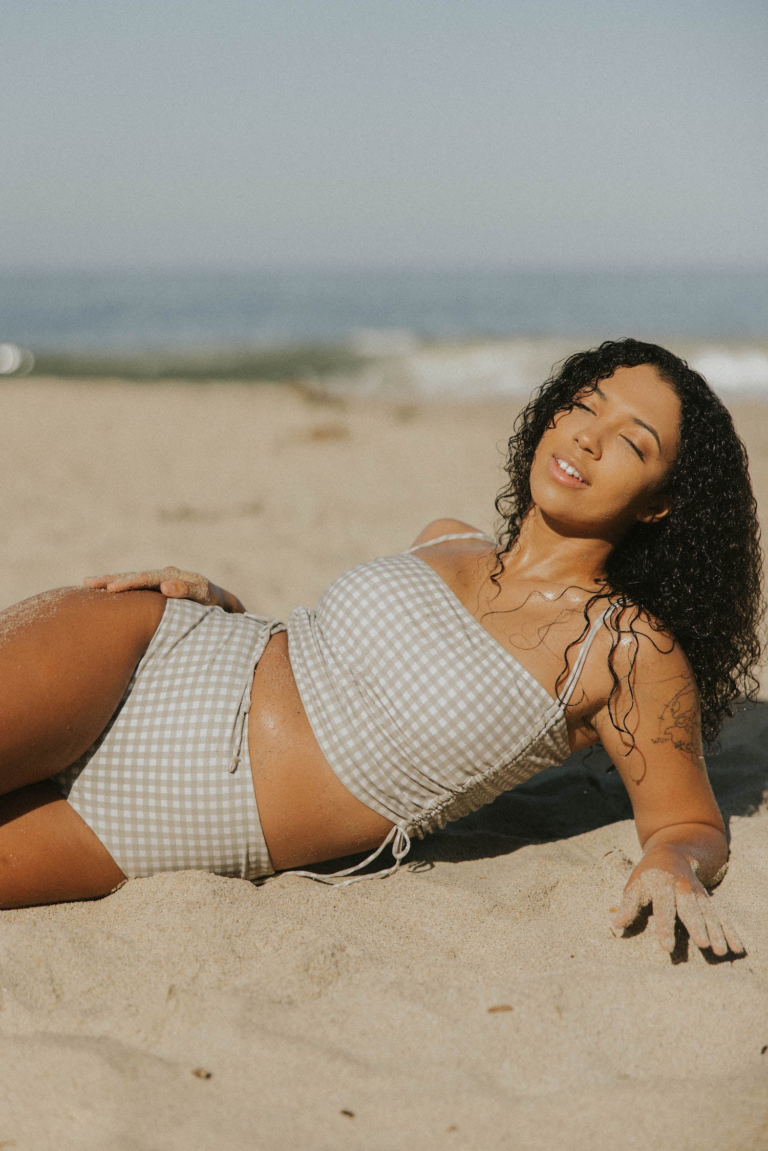 Full coverage gingham bikini top with adjustable ruching sides.