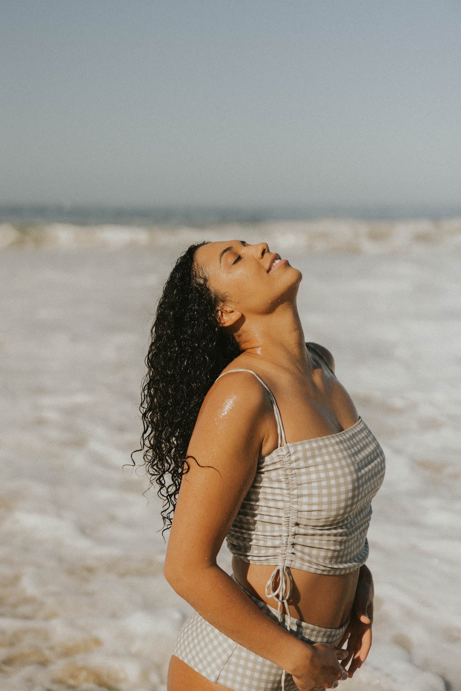 Full coverage gingham bikini top with adjustable ruching sides.