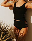 Textured modest black tankini top with floral cutouts. 